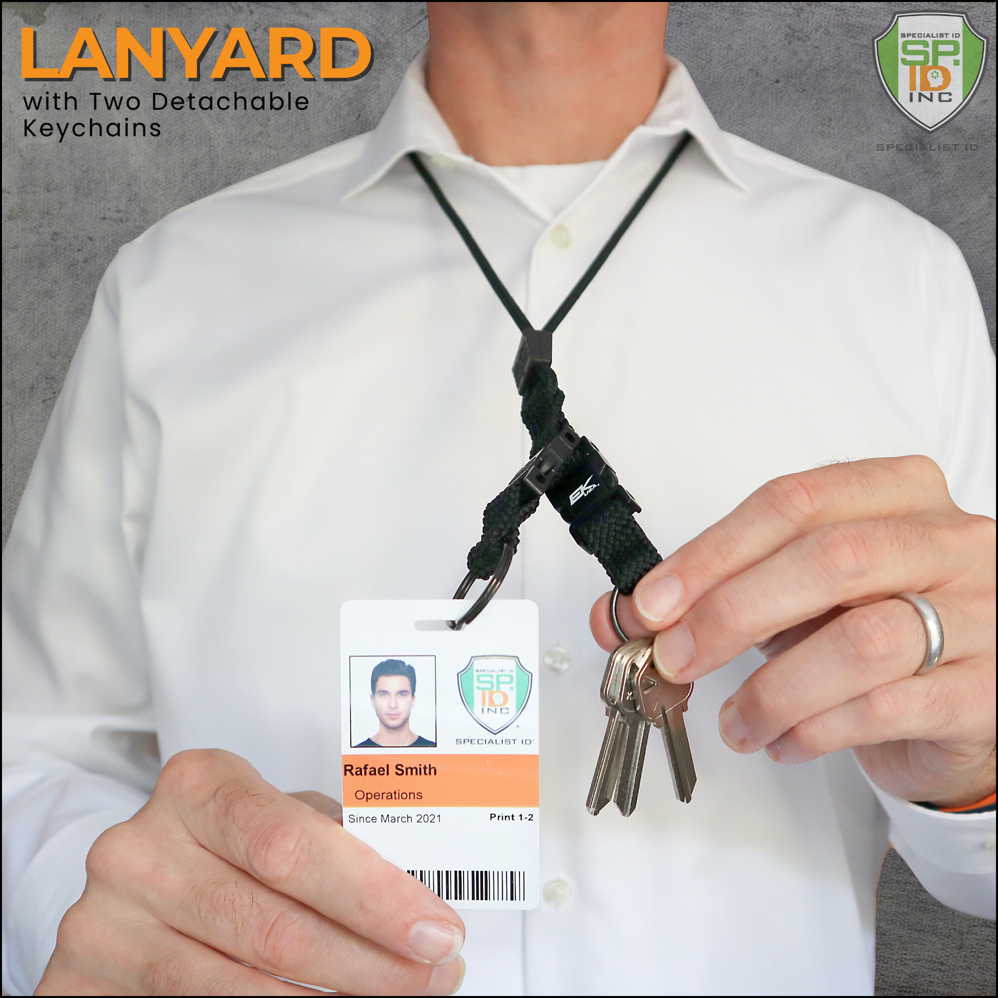 A person wearing the EK Black Lanyard With Two Detachable Key Rings by EK USA, holding keys in their hand.