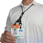 A person in a white shirt holds an ID badge featuring both a photo and text, attached to the Black EK Lanyard Plus II with Two Detachable Soft End Loops (10760) by EK USA.