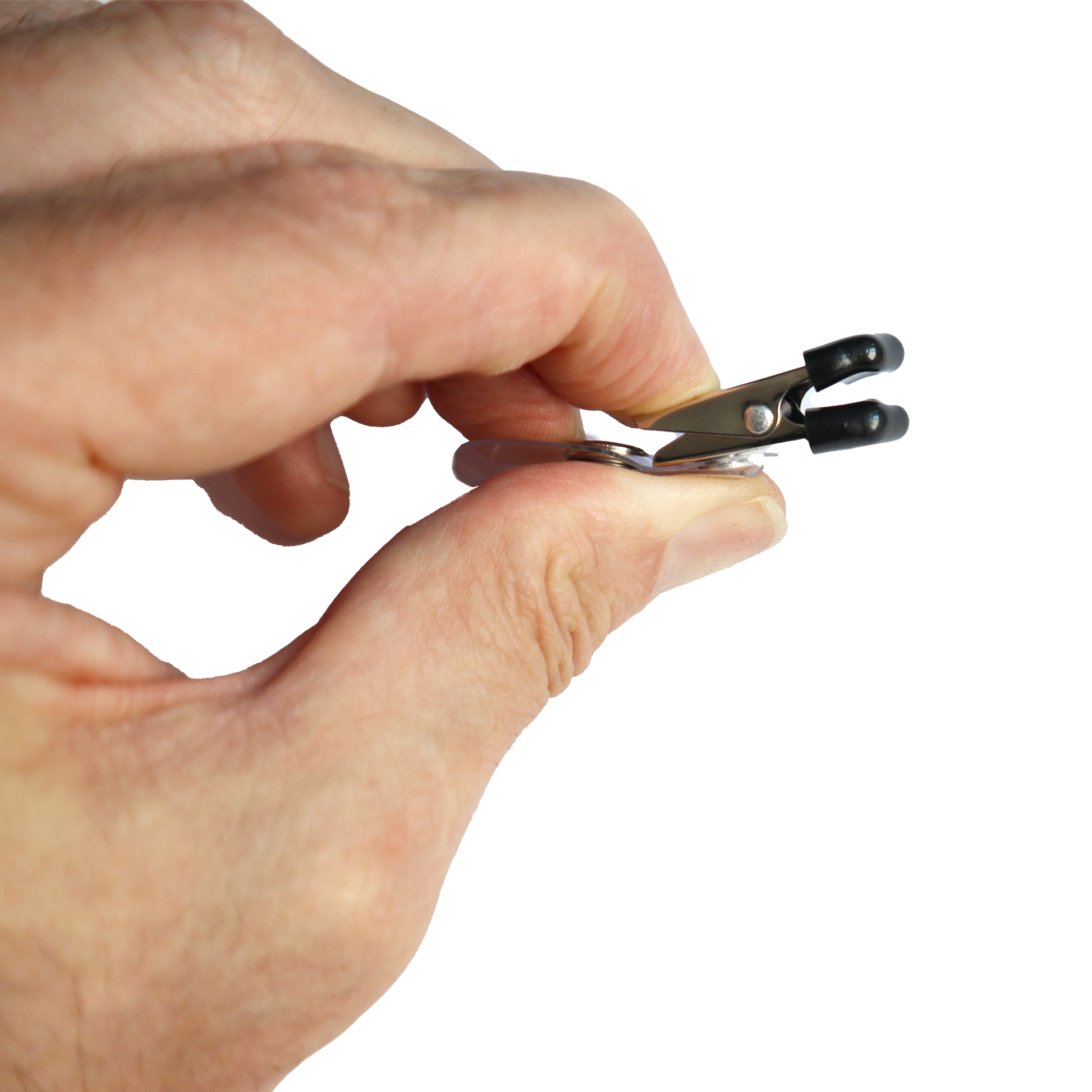 A hand is holding a Clothing Protector ID Strap Clip with Rubber Tip, 2105-3170, featuring black rubber grips and a safety rubber tip, against a white background.