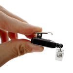 A person gently holds a sleek black Custom Square Retractable Badge Reel with Spring Clip between their fingers against a pristine white background.