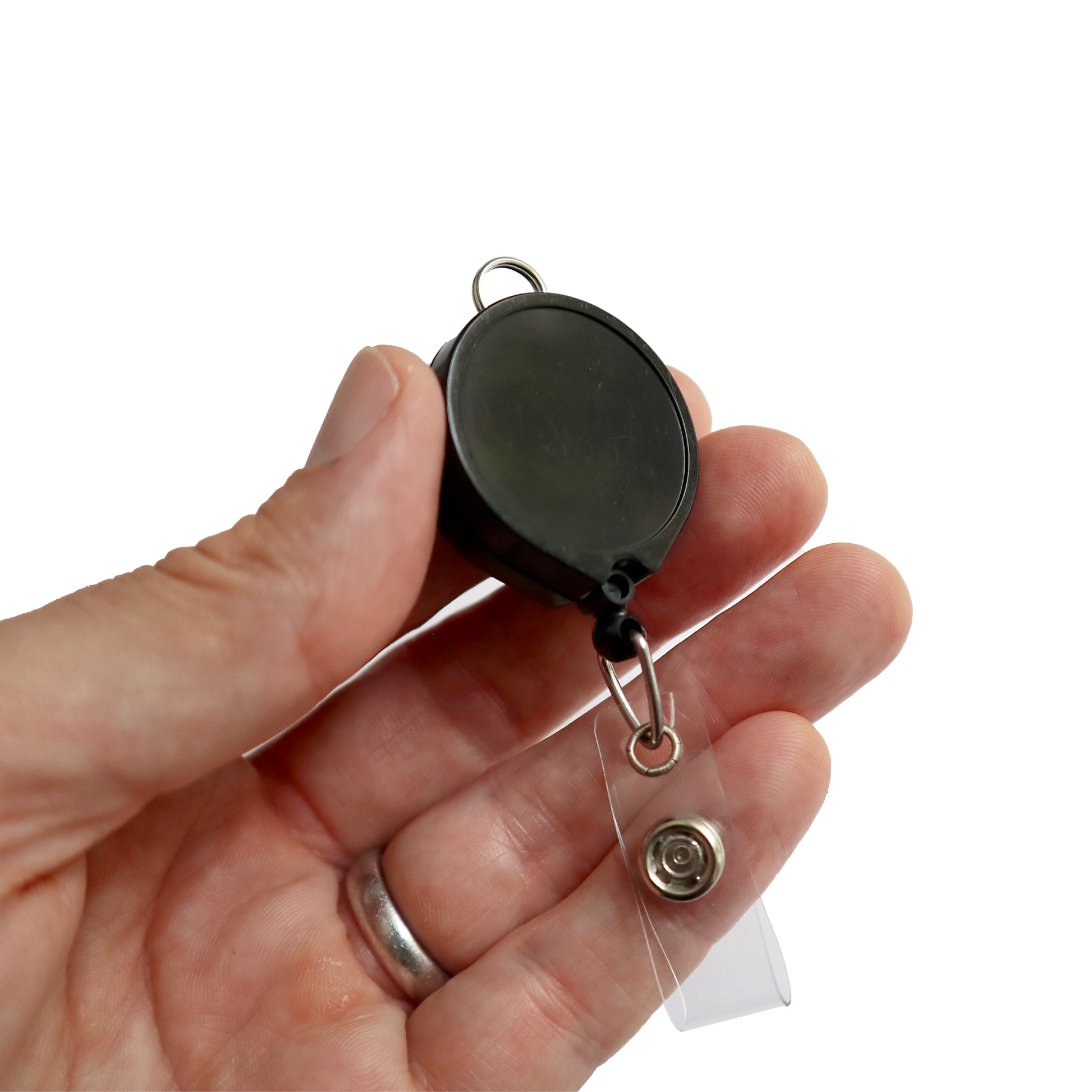 A hand holds a Badge Reel with Lanyard Attachment and Belt Clip (P/N 2124-302X), featuring a round black retractable design with a metal clip and clear plastic loop, ideal for easy lanyard attachment.