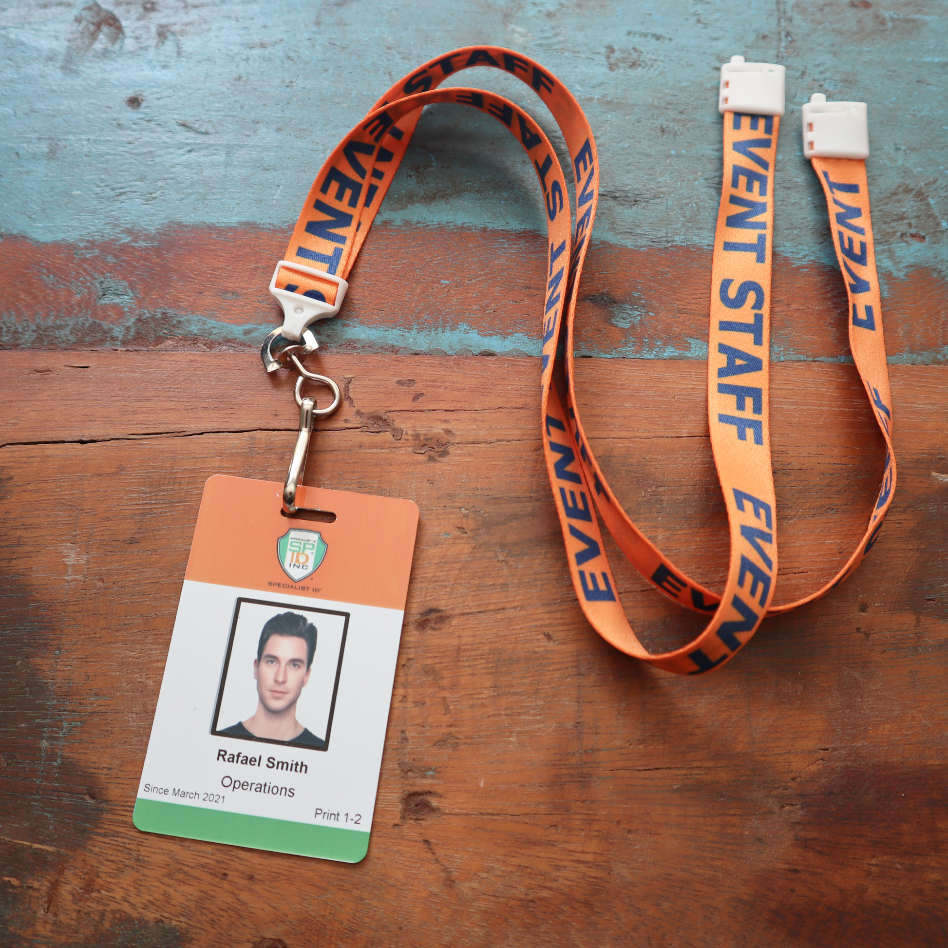 An Orange "Event Staff" Breakaway Flat Lanyard With Swivel Hook (2138-5200), ideal for event staff, offers a practical swivel hook.