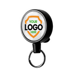 A customizable Key-Bak Mid Size Key Ring Badge Reel with Belt Clip (#6) - Add Your Logo features a circular white face with the text "Your Logo Here" inside an orange shield icon, perfect to personalize and promote brand awareness.