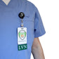 Person wearing blue scrubs with a vertical ID badge holder displaying ID cards, one of which reads "Clear LVN Badge Buddy Vertical with Green Border for Licensed Vocational Nurses.