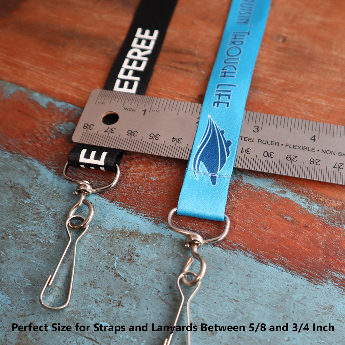 Two lanyards, one black and one blue, are measured against a ruler. The black lanyard reads "REFEREE," while the blue lanyard features a design and text. Both come with sturdy Premium Swivel J Clip Clasp with Wide, Smooth Rounded 3/4 Inch D Ring - DIY Lanyard and Craft Accessories (6905-M-289). The bottom text states strap sizes between 5/8 and 3/4 inch.