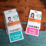 Two employee ID badges on a wooden surface with the names Rafael Smith and Cindy Smith from Operations at Specialist ID Inc., each with a barcode and "Since March 2021". Attached are badge holders "Oversized Fully Customizable Badge Buddy Vertical XL- (Extra Large Size)".