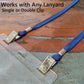 A close-up of a blue lanyard with a double clip attachment is connected to a Vertical Oversized 3x5 Vinyl ID Badge Holder (XL35V) on a wooden surface. The image features text stating, "Works with Any Lanyard, Single or Double Clip" for hands-free display of oversized badges.