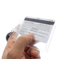 A person's hand holds a white card with a magnetic stripe, encased in a Rigid Fuel Card Holder with Key Ring. Text on the card is partially visible.