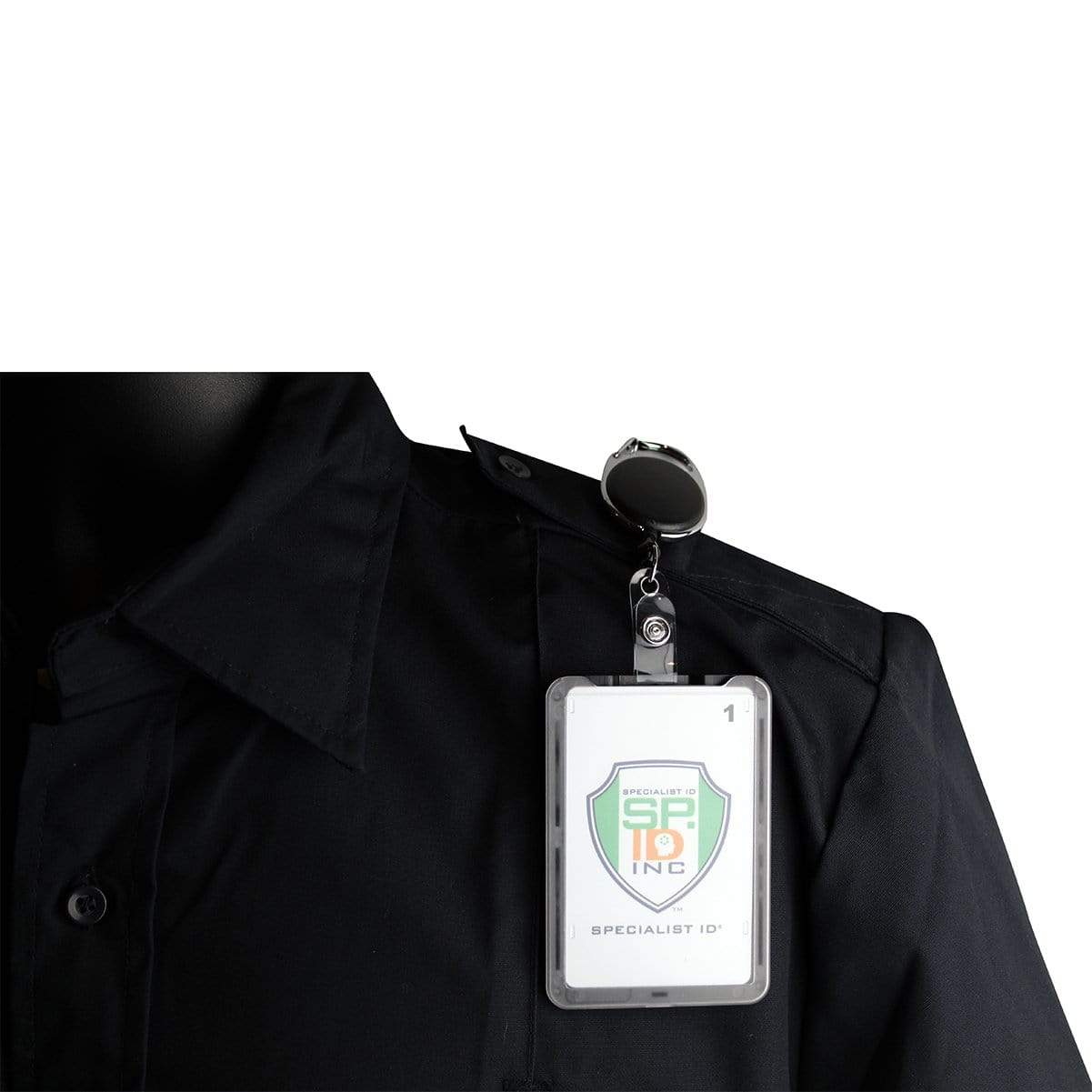 Close-up of a person wearing a black uniform with a Specialist ID badge securely attached to the shirt pocket via a rugged retractable badge reel. The badge, neatly held in a Hard Plastic 3 Card Badge Holder with Badge Reel - Retractable ID Lanyard Features Belt Clip & Carabiner - Rigid Vertical CAC Holder - Top Load Holds Three Cards by SpecialistID, proudly displays a logo and text.