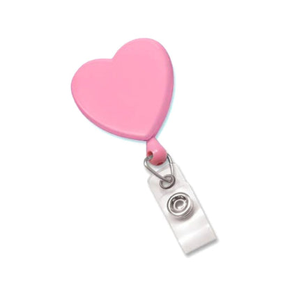 A Heart Shaped Badge Reel With Rotating Spring Clip (P/N 2120-761X) with a clear retractable cord and plastic snap attachment, featuring a swivel spring clip for easy fastening.