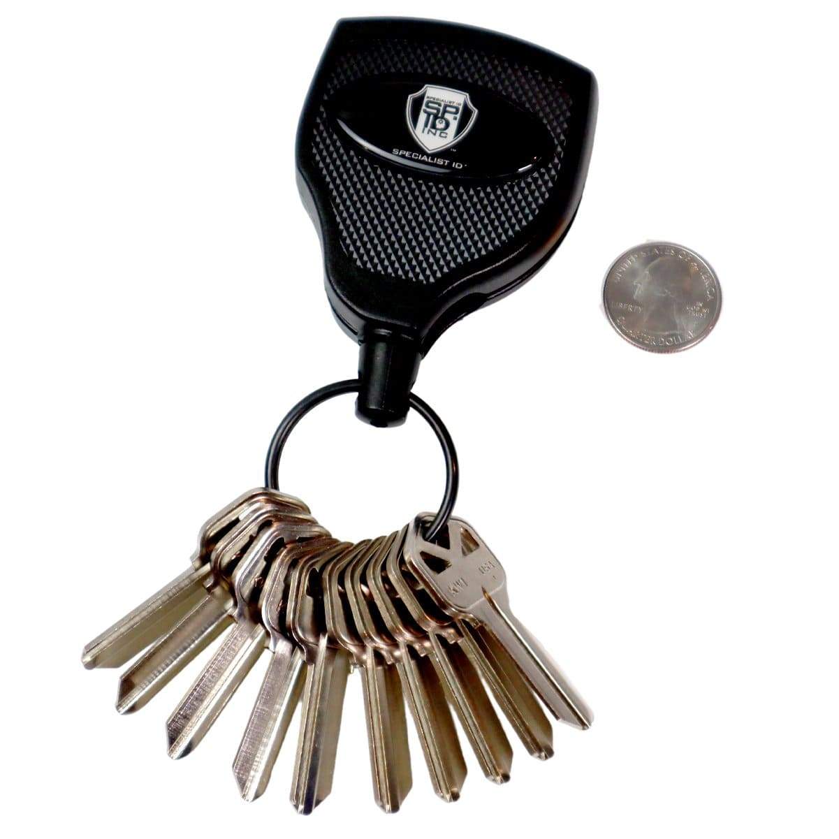 A set of keys attached to a black, textured key holder with a logo, featuring the Super Heavy Duty Retractable Keychain - 8oz or 10 Keys - Durable 48” (4 Ft) Kevlar Lanyard, placed next to a coin for size comparison.