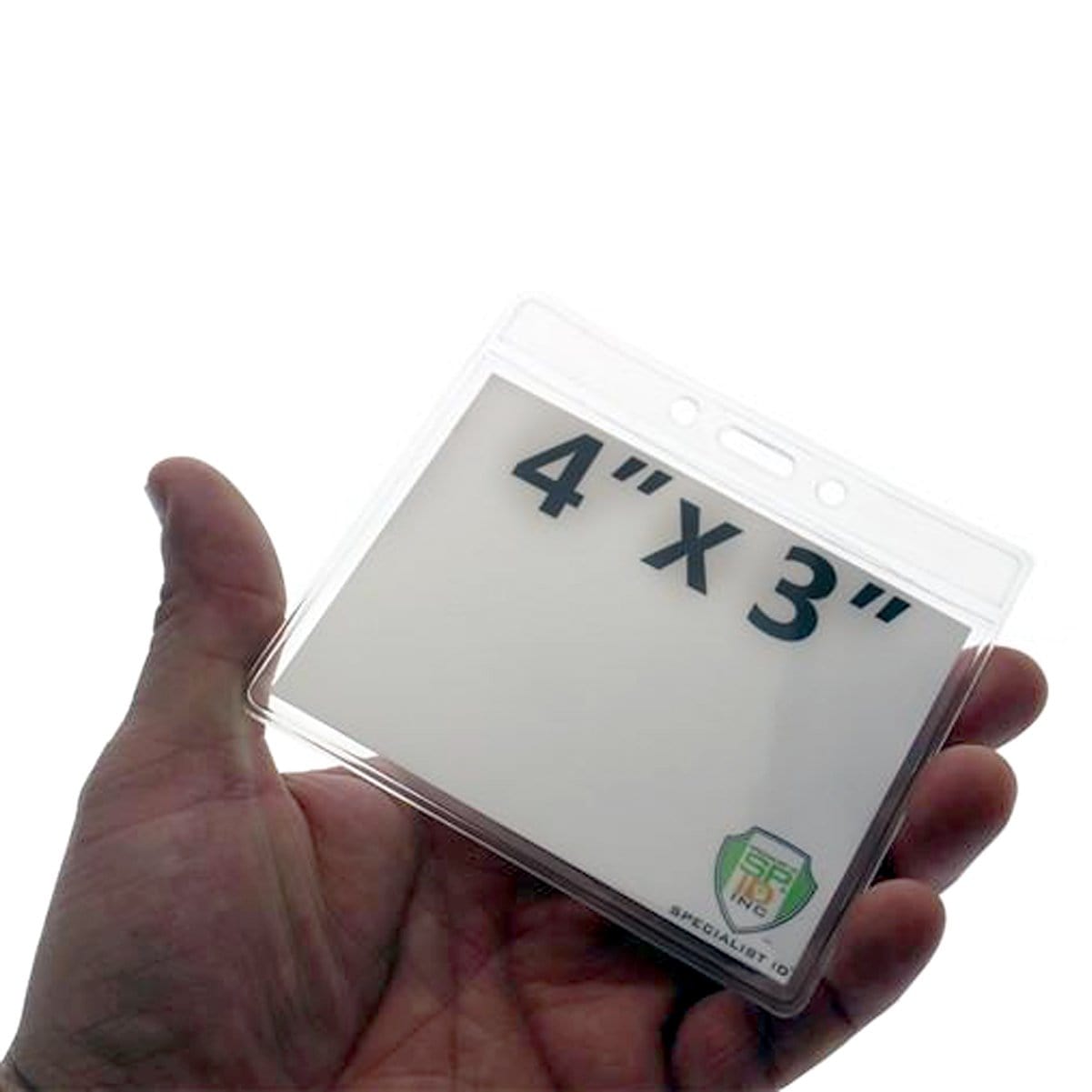 A hand holds a Clear 4X3 Horizontal Convention Size Badge Holder (406-J-CLR), showcasing a white card labeled "4″ x 3″" in horizontal convention size, ensuring ID protection.