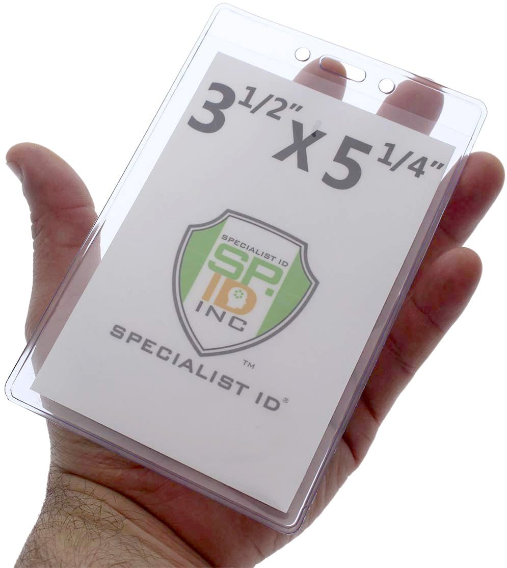 A hand holding a Premium 3 1/2 x 5 1/4 Clear Vinyl Vertical Extra Large Badge Holder (506-46), displaying a card inside with the text "3 1/2" x 5 1/4"" and a logo with "SPECIALIST ID INC.